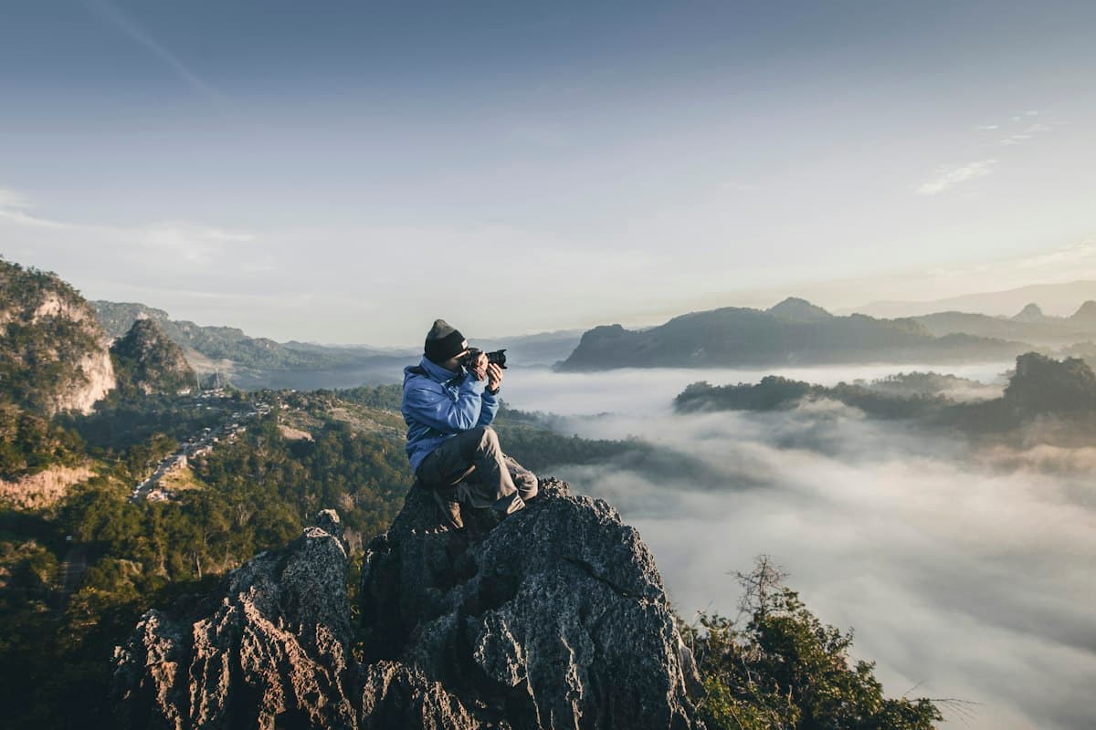 Photographer with camera capturing a scene for video or photo content