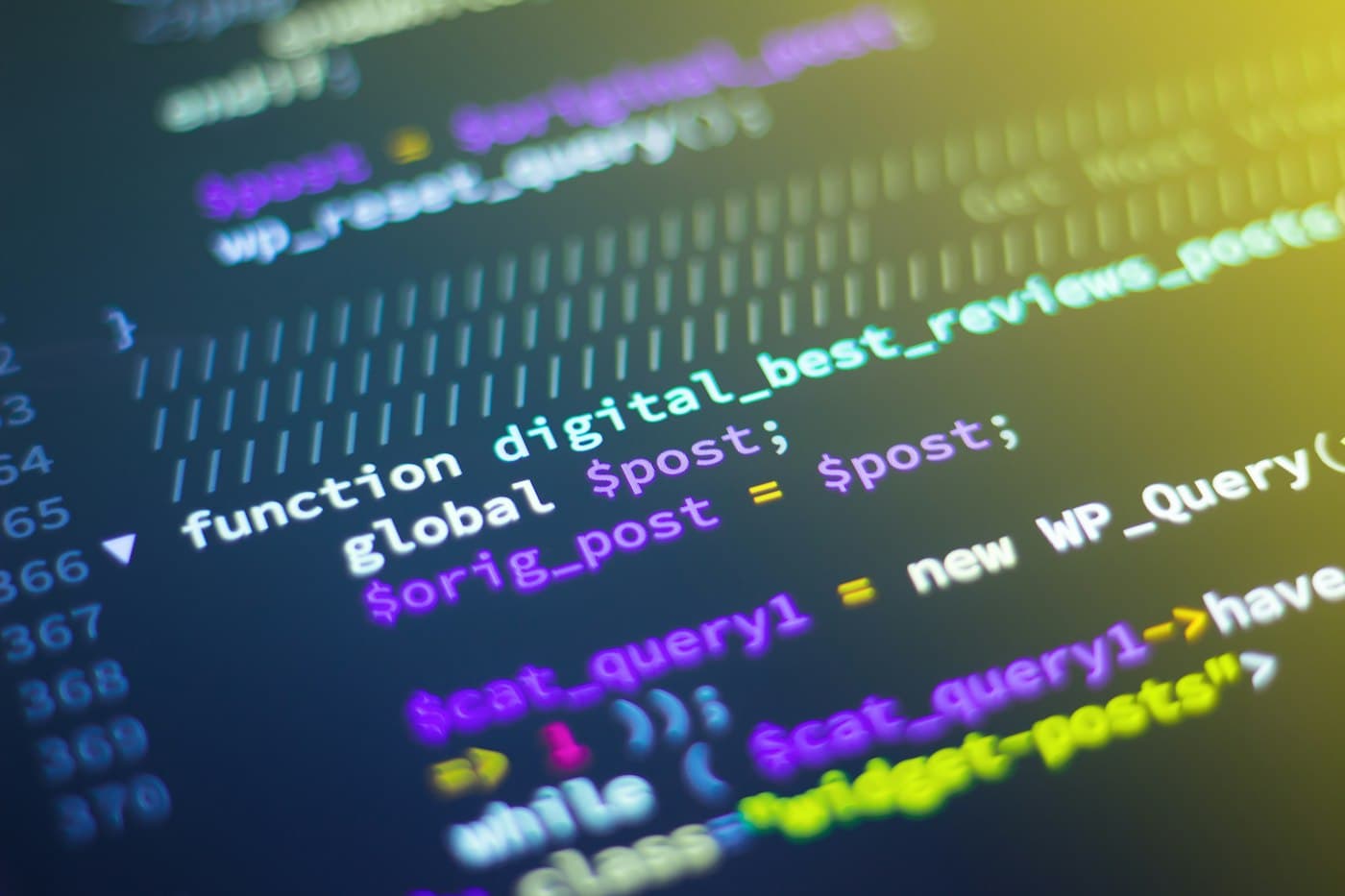 Developer working with code on multiple monitors